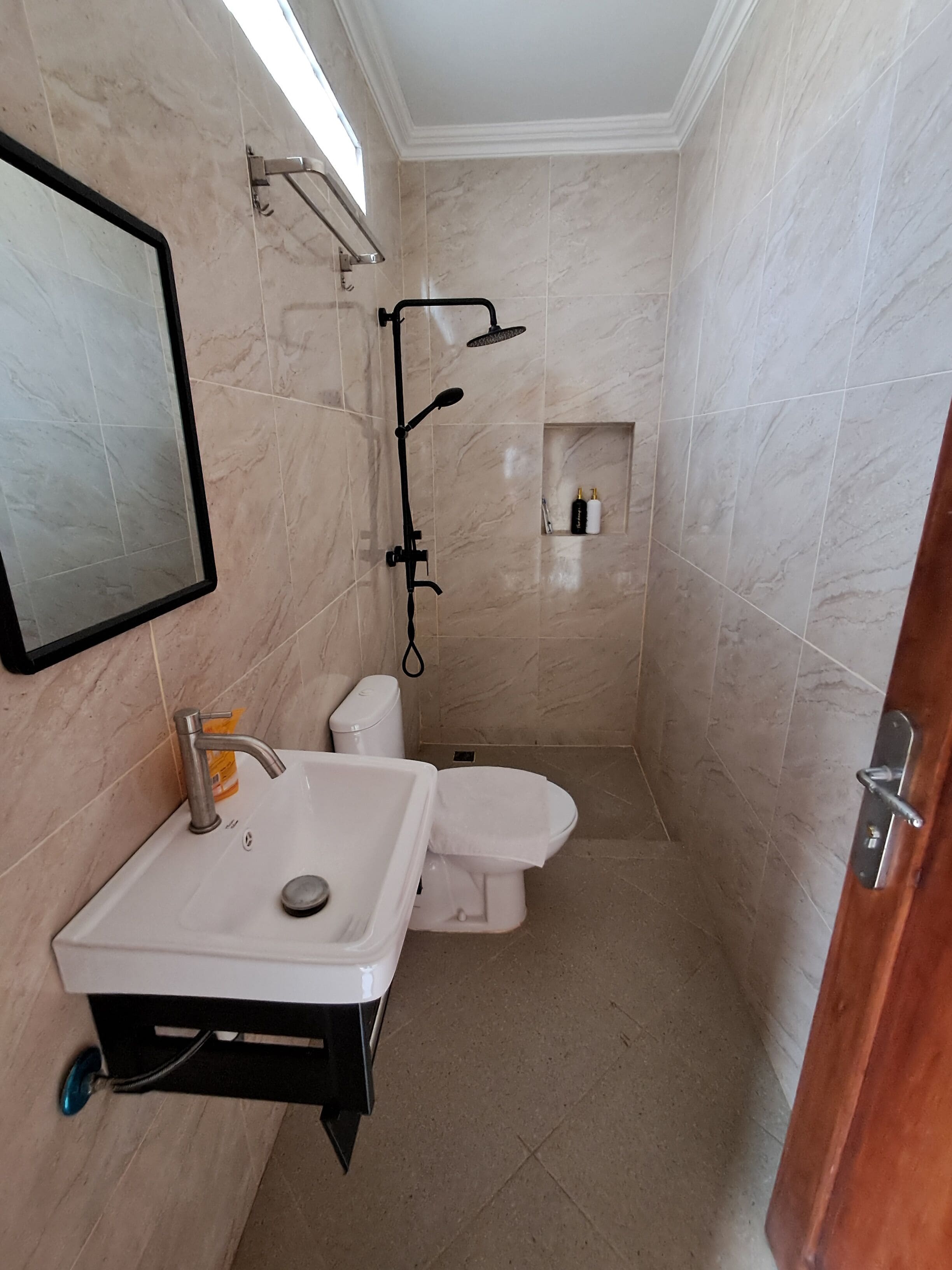 A bathroom with a sink, toilet, and shower.
