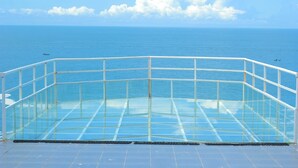 A glass-enclosed balcony with a view of the sea. - Teras Kaca (Panggang)