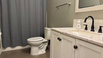 Shower, hair dryer, towels, toilet paper