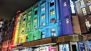A multi-story building with illuminated signage and a ground-level restaurant. - Southampton City View Apartment (Southampton)