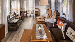 A cozy living room with a sofa, wooden coffee table, and a dining area with a table and chairs. - Awesome home in Hultsfred with sauna (Hultsfred)