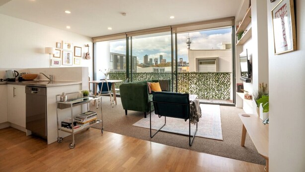 A modern apartment with a kitchen, dining area, and a balcony with a city view. - Eclectic City-Fringe Townhouse with Rooftop Deck (Auckland)