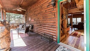 A wooden cabin with a covered porch, a staircase leading to the main entrance, and a sign reading "BEAMERS DUGOUT".