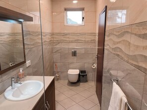 Shower, towels, soap, toilet paper