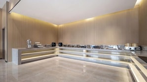 A modern, minimalist reception area with a sleek counter, a coffee machine, and a kettle. - Shanghai Eagle Hotel (Shanghai)