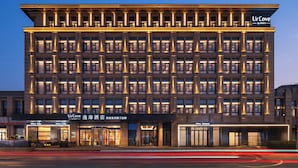 A multi-story hotel with a modern facade, illuminated windows, and signage for 'Ur Cove by Hyatt'. - UrCove By Hyatt Yangzhou Dongguan Street (Yangzhou)