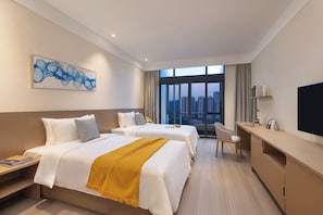 A hotel room with two beds, a desk, a chair, a TV, and a large window with a city view. - Keymore Residence Guangzhou (Guangzhou)