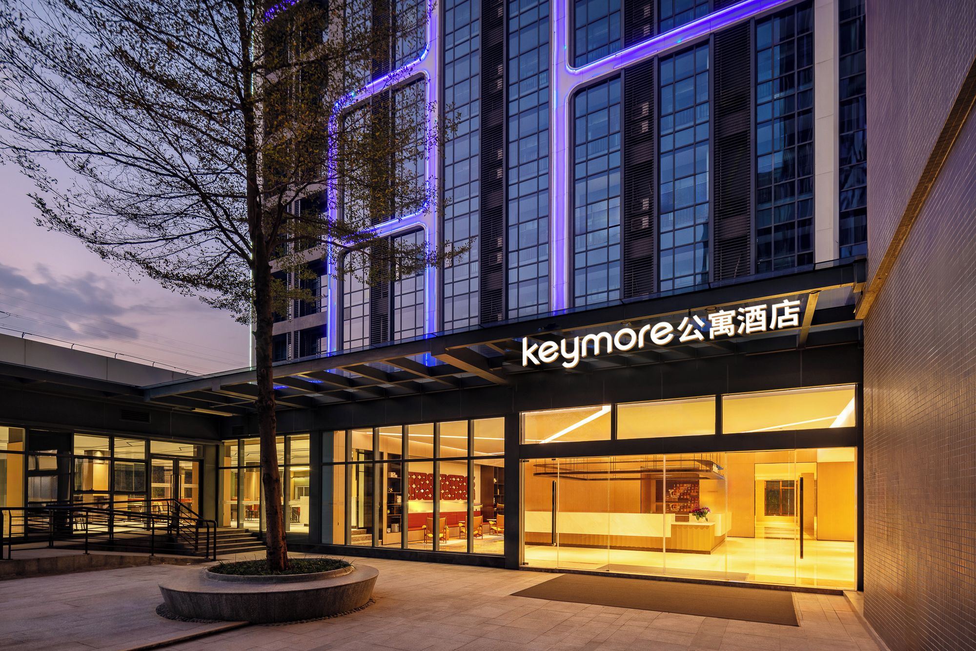 A hotel with a modern facade, large windows, and a prominent signage.