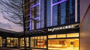 A hotel with a modern facade, large windows, and a prominent signage. - Keymore Residence Guangzhou (Guangzhou)