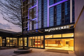 Ein Hotel mit einer modernen Fassade, großen Fenstern und einer gut sichtbaren Beschilderung.