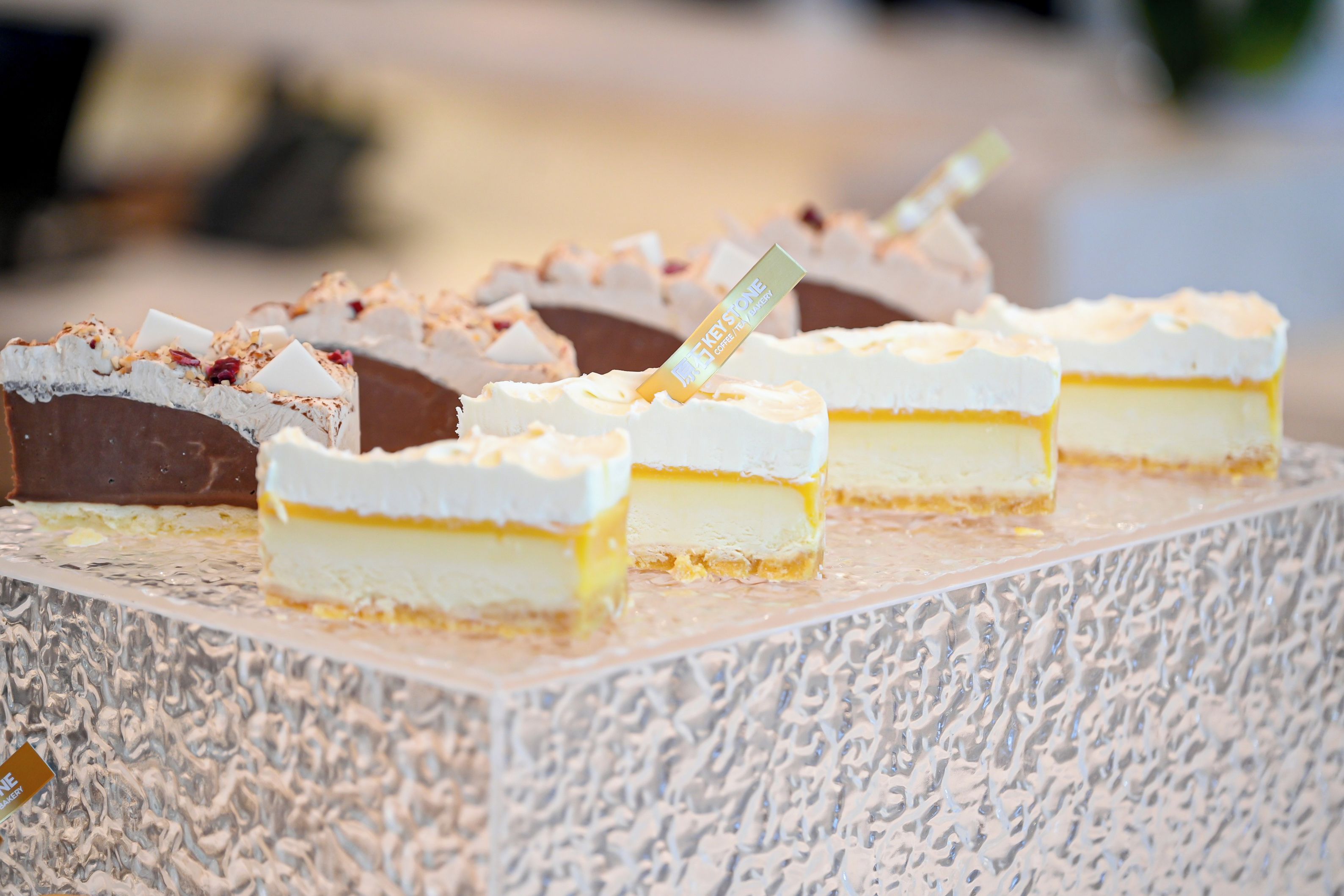 A selection of desserts on a textured serving board.