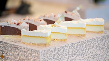 A selection of desserts on a textured serving board.