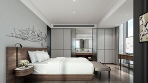 A modern bedroom with a large bed, bedside tables, a vanity with a mirror, and artwork on the walls. - UrCove by Hyatt Lianyungang Railway Station Suning Plaza (Lianyungang)