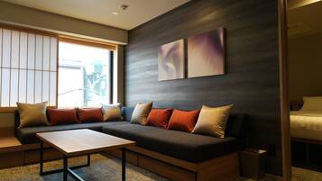 A modern living room with a sectional sofa, a wooden coffee table, and abstract wall art.