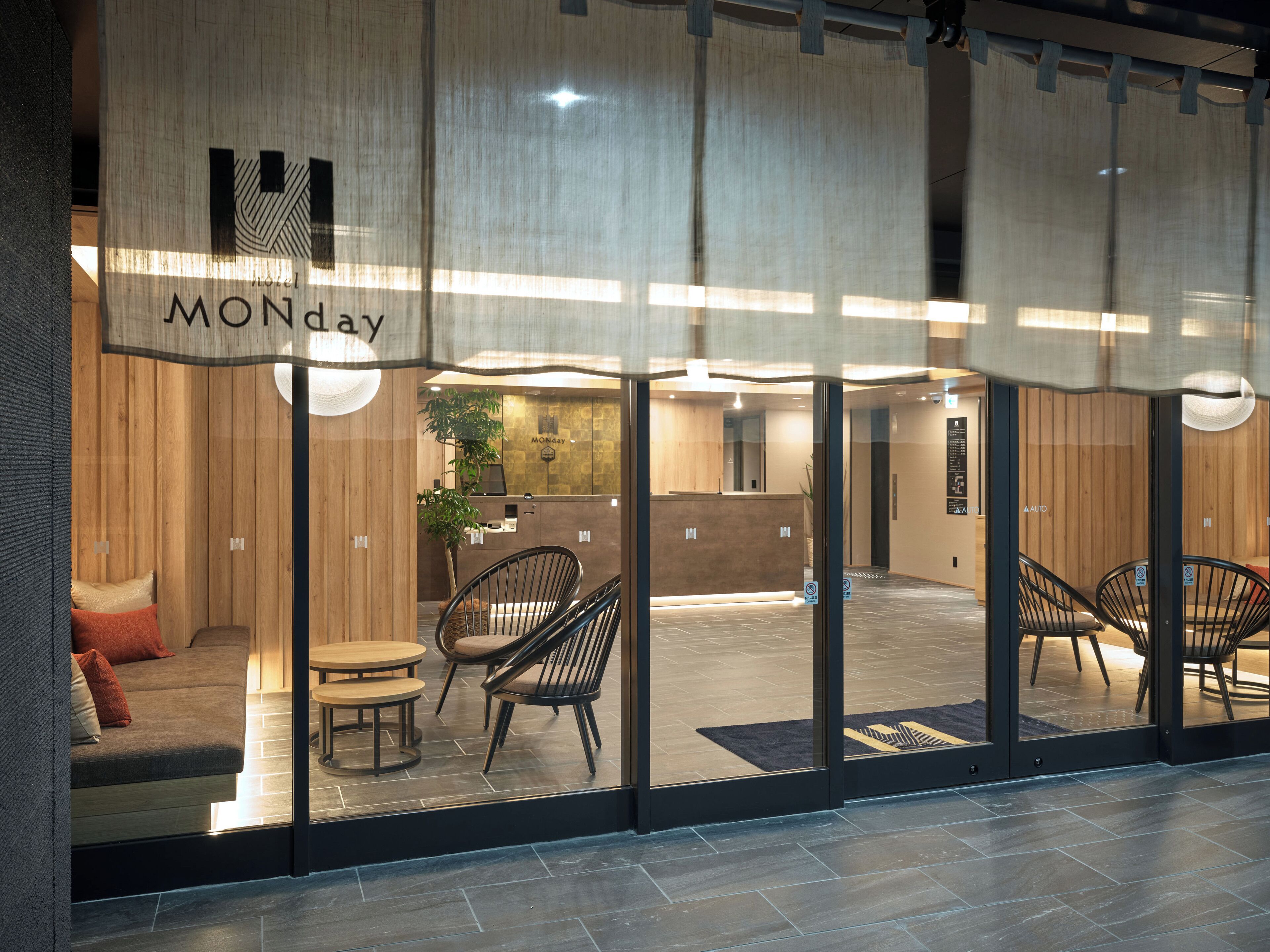 A hotel reception area with a wooden interior, a reception desk, and seating arrangements.