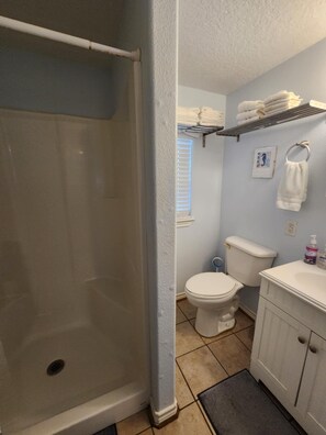 Shower, towels, soap, toilet paper