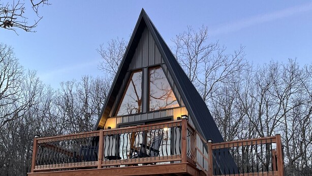 A cabin with a wooden deck, a balcony, and a large window. - `The Scout`: a cozy mountain cabin with million dollar view (Ironton)