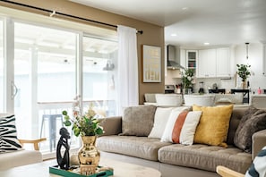 Relax in this inviting living space with a cozy sofa and modern kitchen area.