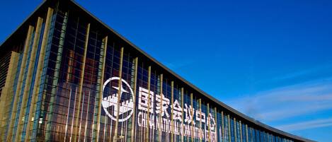 A modern building with a prominent logo and signage indicating it is the National Convention Center.