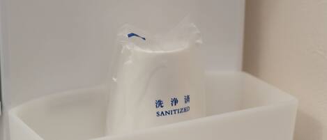 A white container with a blue label that reads "SANITIZED".