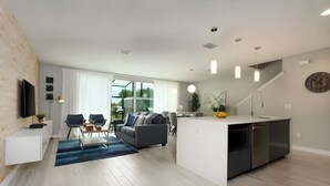 Un apartamento moderno con sala de estar, comedor y cocina.