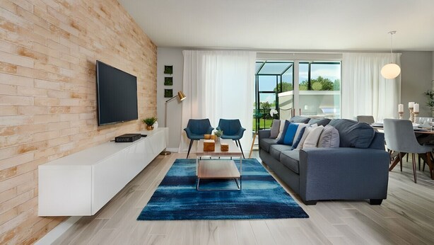 Una sala de estar moderna con un televisor grande, un sofá, una mesa de centro y un comedor con mesa y sillas.