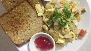 A plate with scrambled eggs, toast, butter, and jam. - Hotel badrinath (Kathmandu)