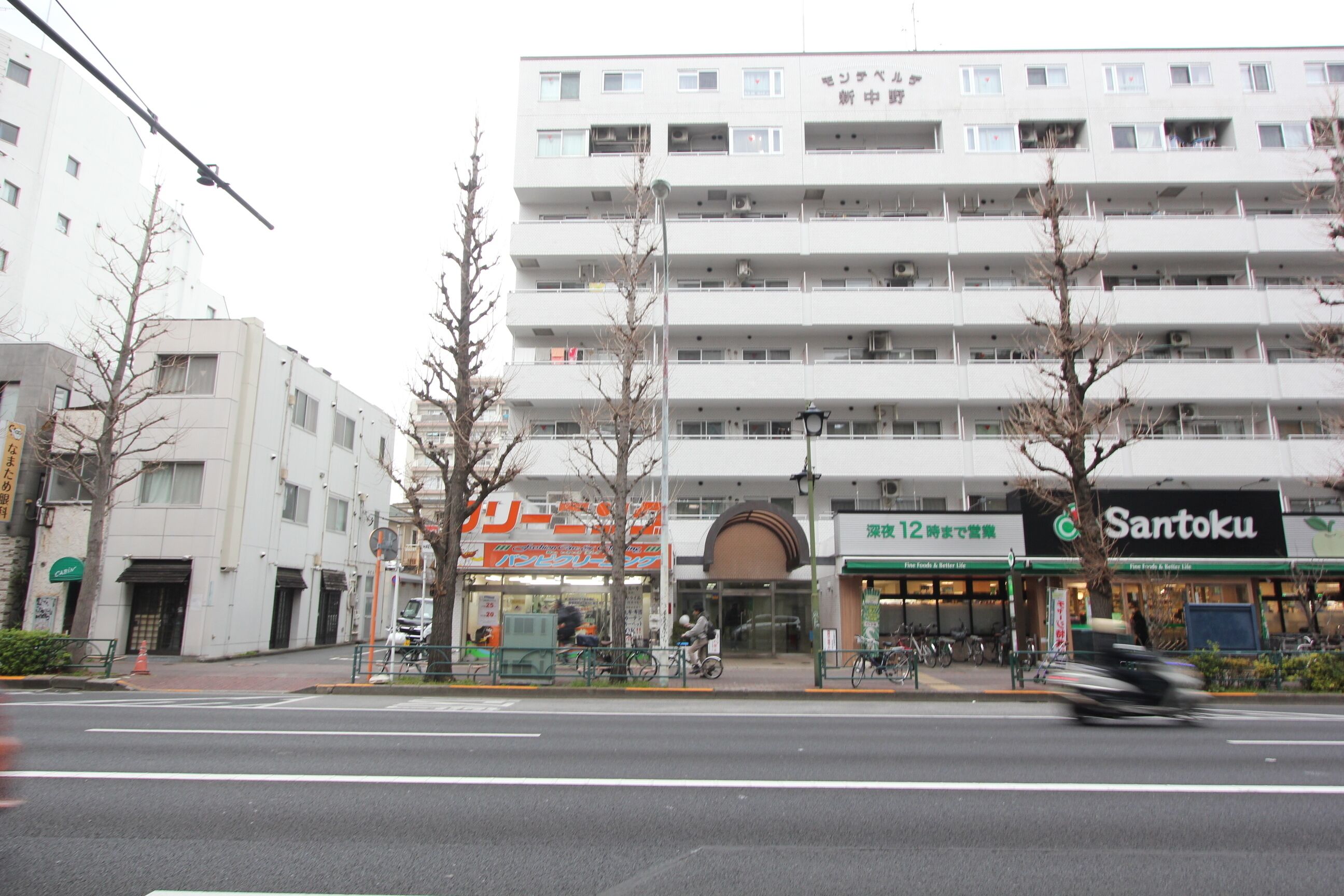 A multi-story building with a storefront labeled "Santoku."