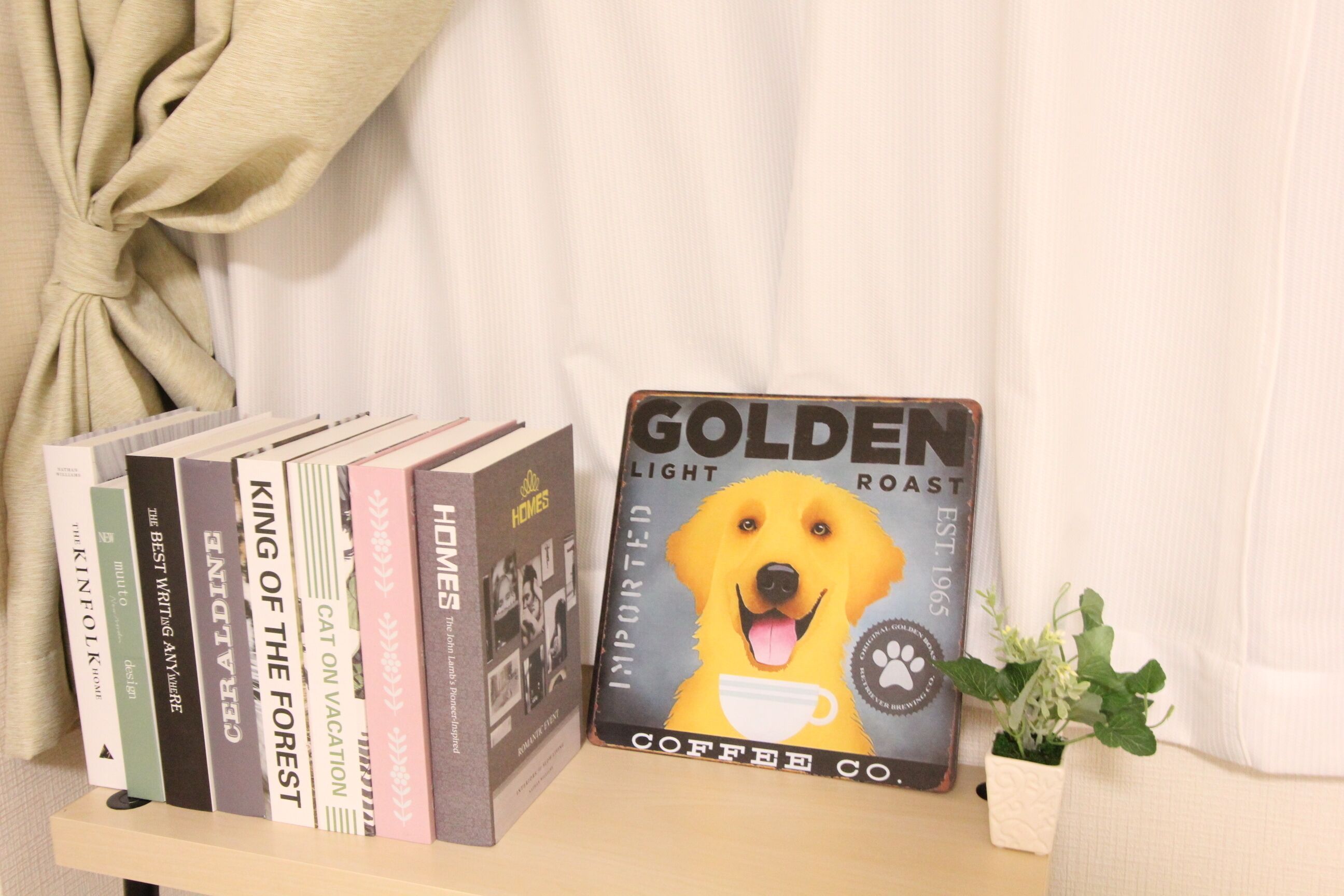 A shelf with books and a coffee-themed book titled "GOLDEN LIGHT ROAST".
