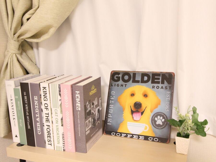A shelf with books and a coffee-themed book titled "GOLDEN LIGHT ROAST".