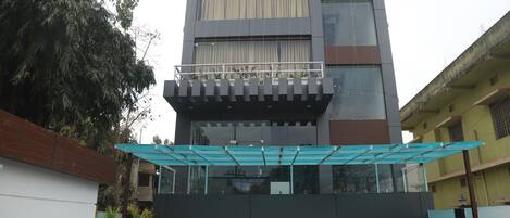 Un edificio moderno con ingresso in vetro e una passerella coperta.
