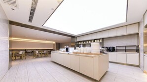 A modern kitchen with a central island, built-in appliances, and a skylight. - Full Season Hotel (Qingdao)