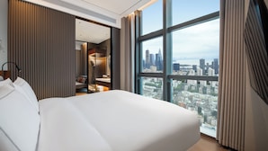 A modern hotel room with a large bed, a city view, and a walk-in closet. - UrCove by Hyatt Shenzhen Bay Nanyou (Shenzhen)