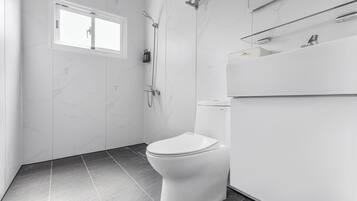 Standard Quadruple Room | Bathroom | Shower, hair dryer, slippers, towels