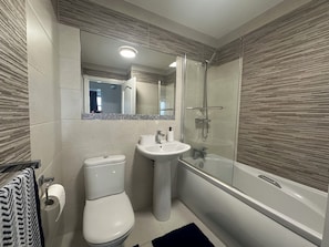 Shower, hair dryer, towels, toilet paper
