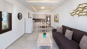 A modern apartment with a kitchen, dining area, and living room. - Pithos apartments is a complex of 5 full equipped apartments (Thira - Santorini)