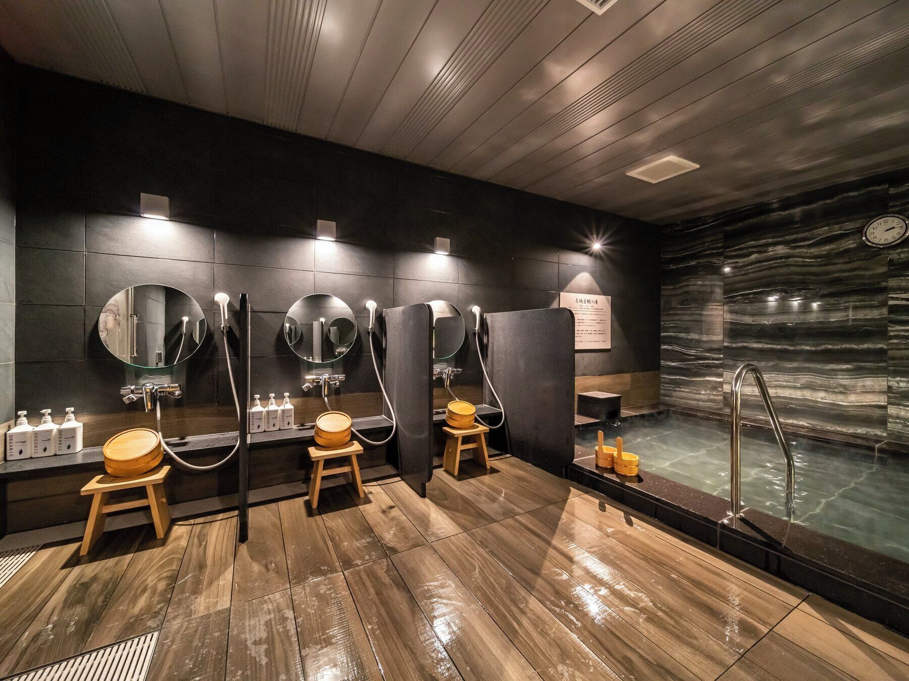 A modern bathroom with multiple sinks, mirrors, and a steam shower.