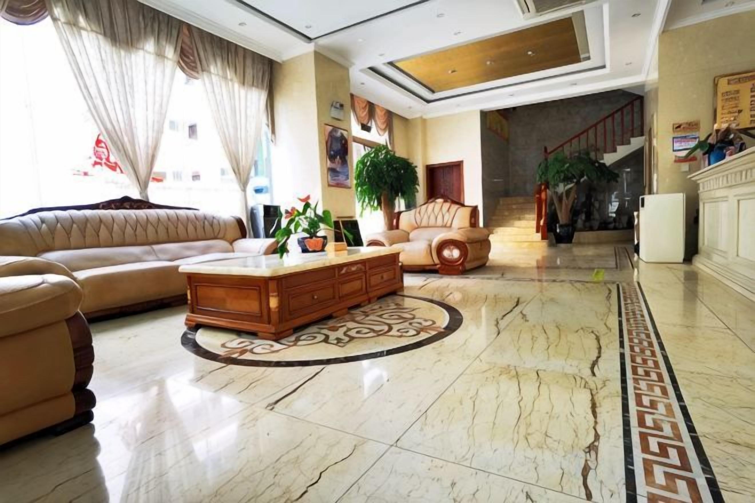 A spacious living area with a sofa, a coffee table, and a decorative rug.