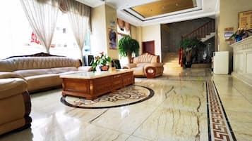 A spacious living area with a sofa, a coffee table, and a decorative rug.