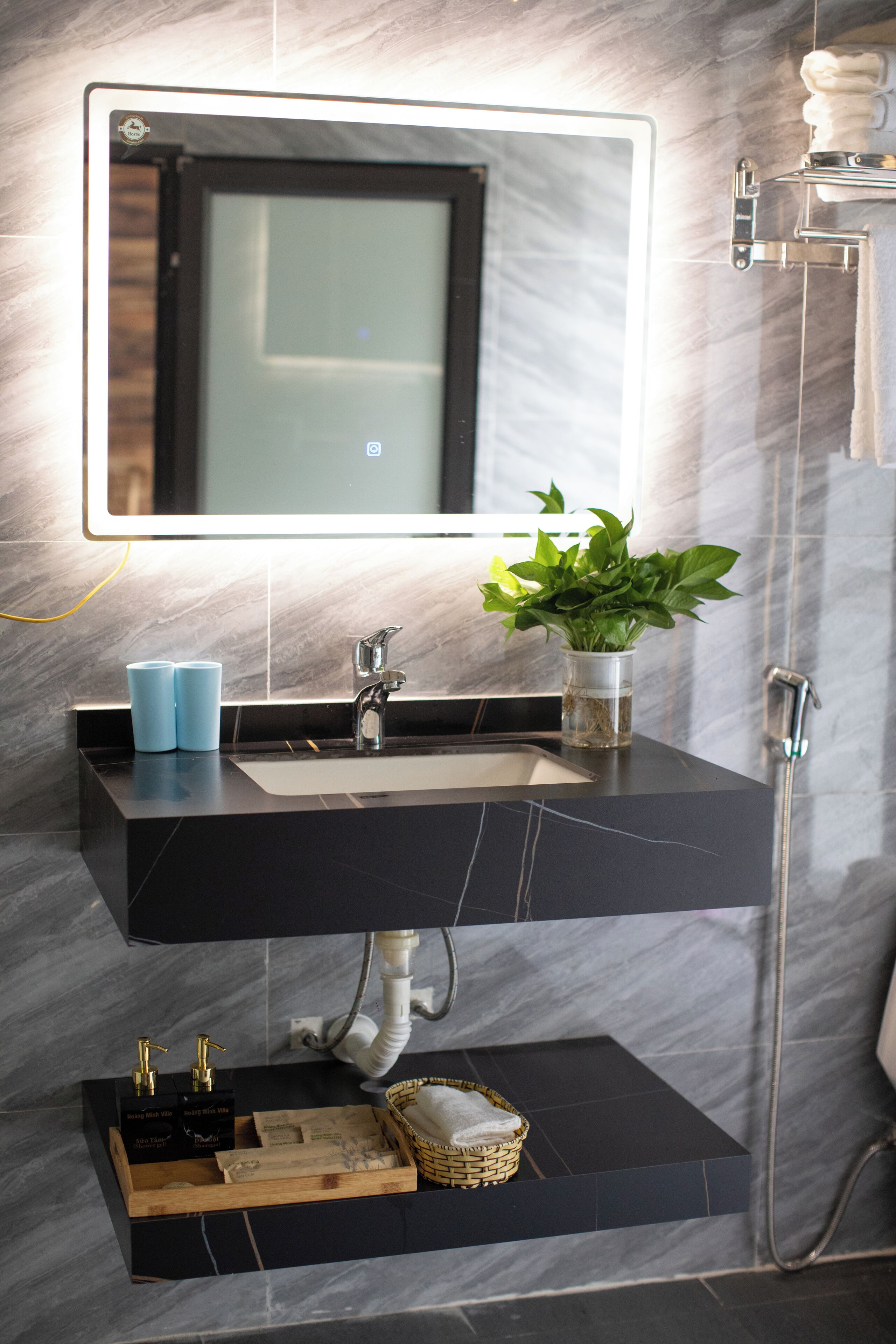 A modern bathroom with a dual sink vanity, a large mirror, and a shower area.