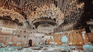A banquet hall with multiple round tables, elegant chandeliers, and a decorative ceiling. - Yingkou International Hotel (Yingkou)