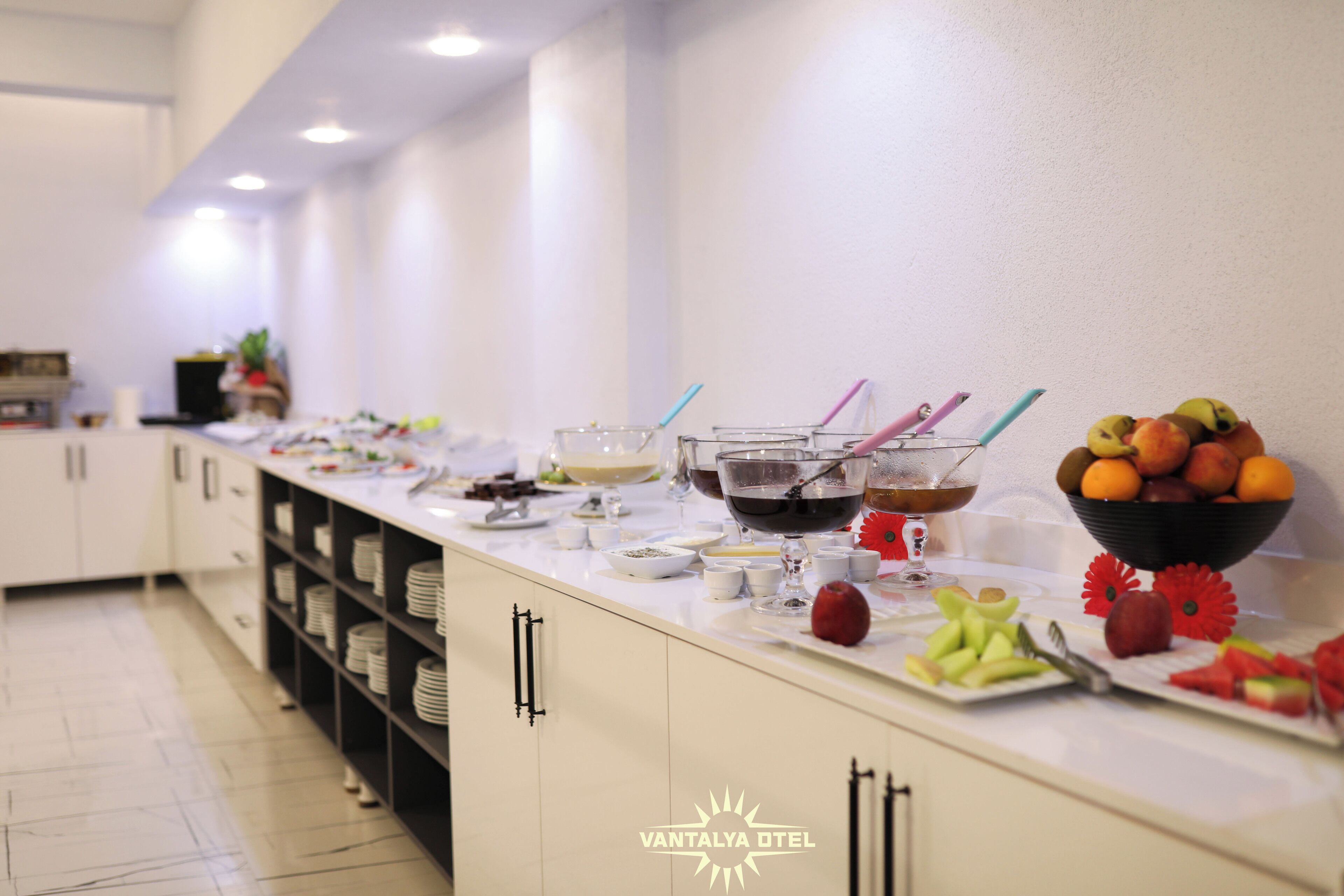 A buffet setup with various food items and beverages.