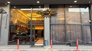 The entrance to VANTALYA HOTEL with a glass facade, a star-shaped sign above the entrance, and a chain barrier in front. - Vantalya Otel (Van)