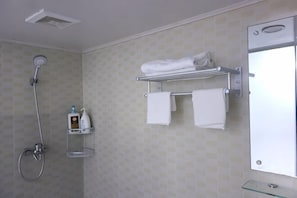 A bathroom with a shower, a towel rack, and a glass shelf with toiletries. - Huike Hostel (Shanghai)