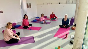 A group of people seated on yoga mats in a room with a white wall and a window. - Relaxation and Well-being break near Bordeaux | Yoga & Swimming pool (Chatenet)