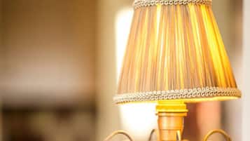 A vintage-style table lamp with a decorative base and a lampshade with a pleated design.