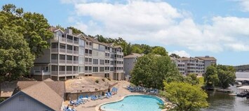 Relax in a stunning pool with panoramic lake views, perfect for unwinding in style.