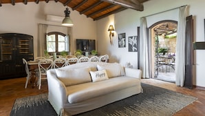 Una sala de estar acogedora con un sofá, una mesa de comedor y una zona de cocina.