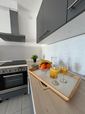 Enjoy cooking in this well-equipped kitchen with an oven and range hood.