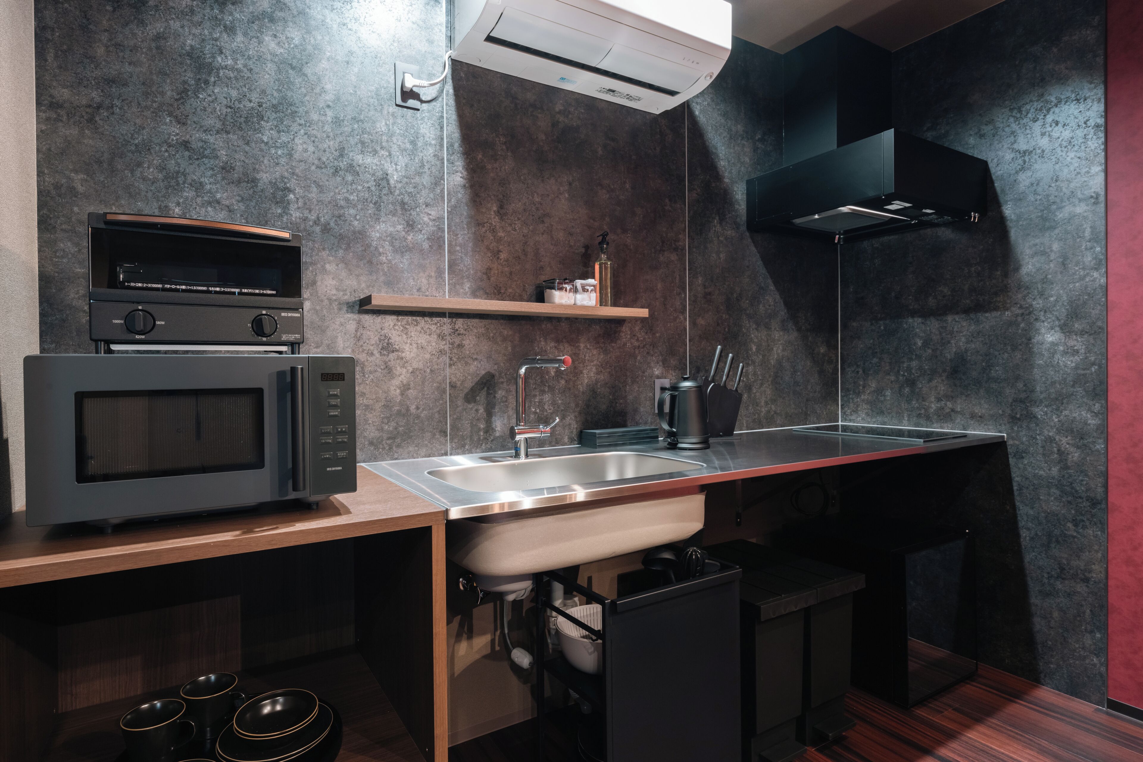 A modern kitchen with a microwave, sink, and built-in oven.